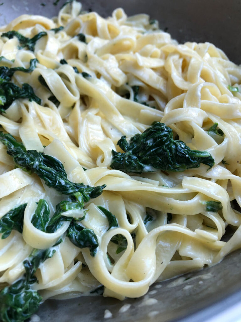 Spinach and mascarpone pasta in a large skillet.