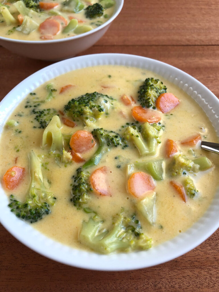 Broccoli cheese soup served in bowls.