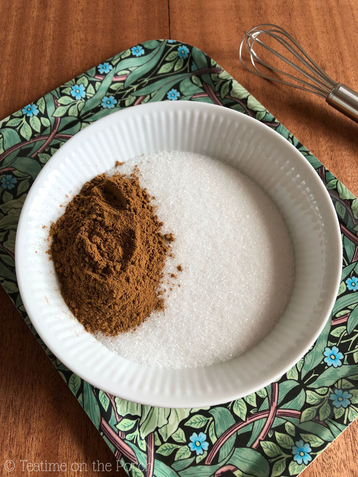 Sugar and ground cinnamon in a small bowl.