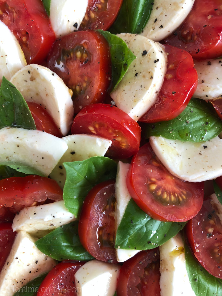 Easy Caprese Salad Sliced tomatoes, fresh mozzarella, and fresh basil leaves drizzled with olive oil and balsamic vingear and sprinkled with salt and pepper to create a caprese salad.