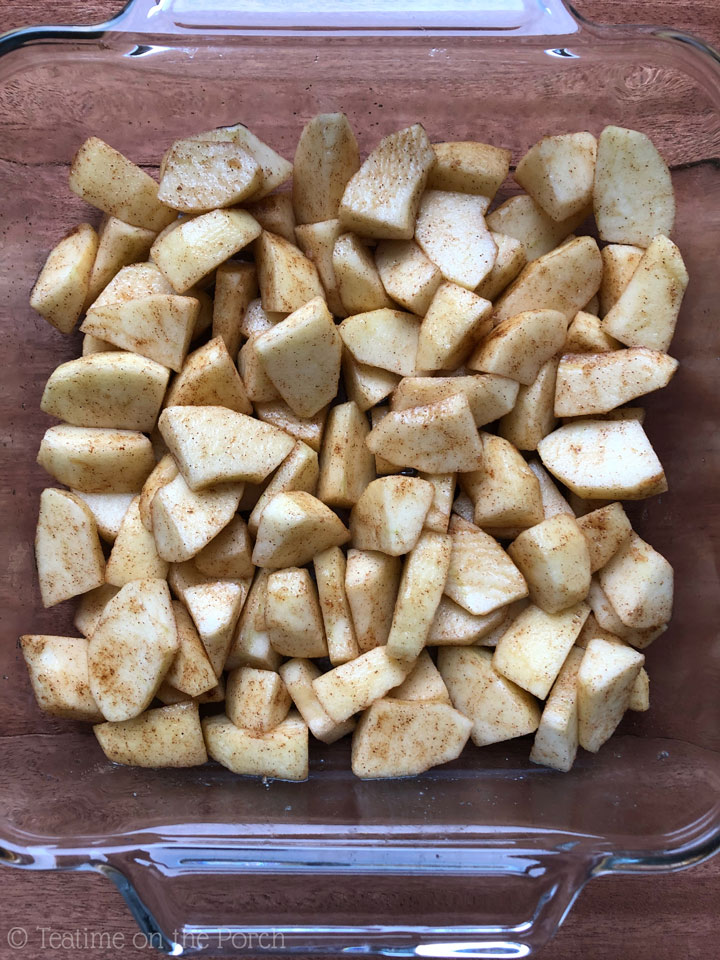 How to Make the Best Healthy Apple Crisp Chopped apples tossed with sugar and cinnamon in an 8-inch square glass baking dish.