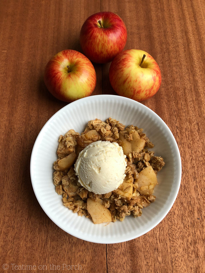 The Best Healthy Apple Crisp Healthy apple crisp served in a bowl with a scoop of vanilla ice cream on top, from a bird's eye view.