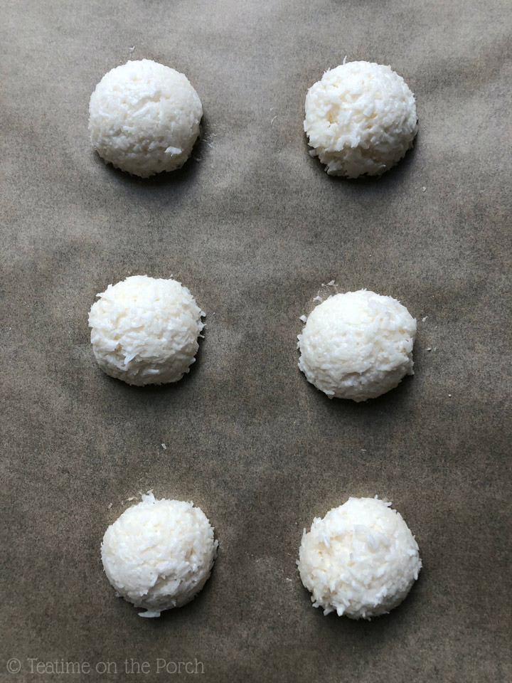 How to Make the Best Healthy Coconut Macaroons Shaped coconut macaroons on a baking sheet ready to be baked.