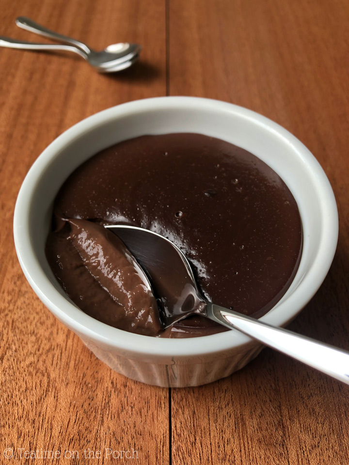 Homemade Chocolate Pudding Recipe Homemade chocolate pudding served in a white ramekin with a spoon.