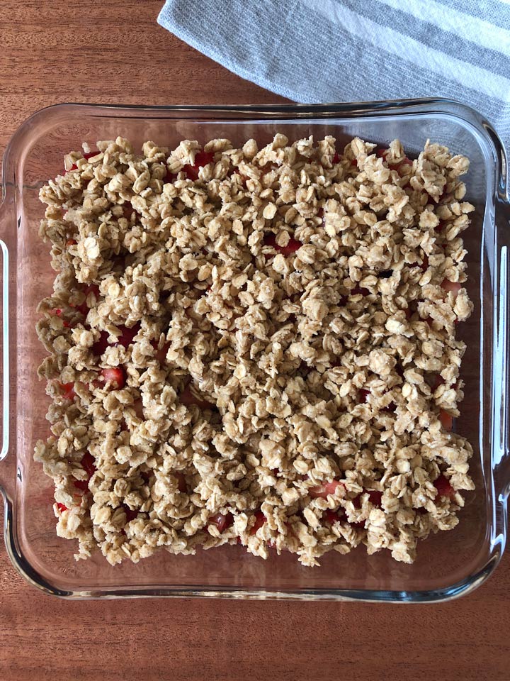 Vegan Strawberry Crisp Recipe Healthy strawberry crisp in an 8-inch square pan before baking.